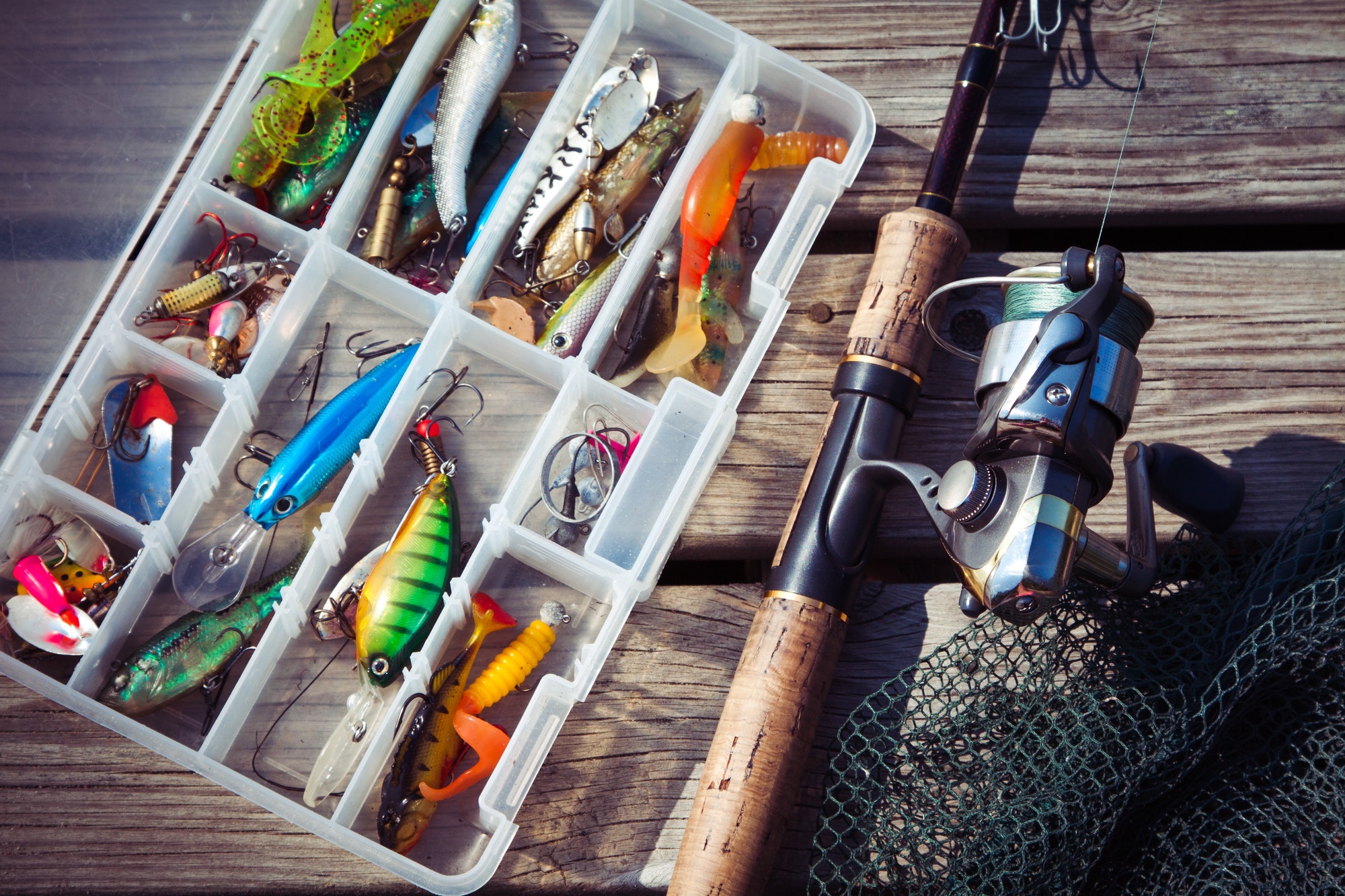 fishing-lures-in-tackle-boxes-with-spinning-rod-and-net.jpg